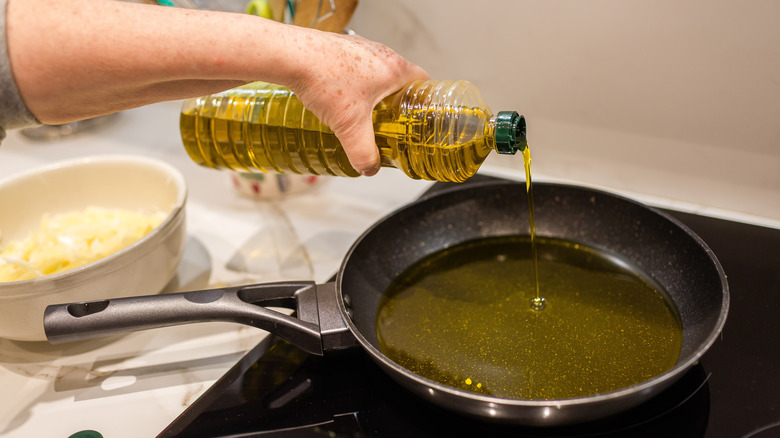 Pouring oil into pan