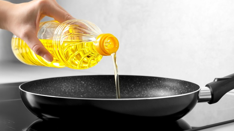 Pouring oil into frying pan