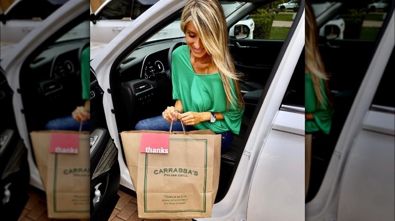 woman holding Carrabba's food