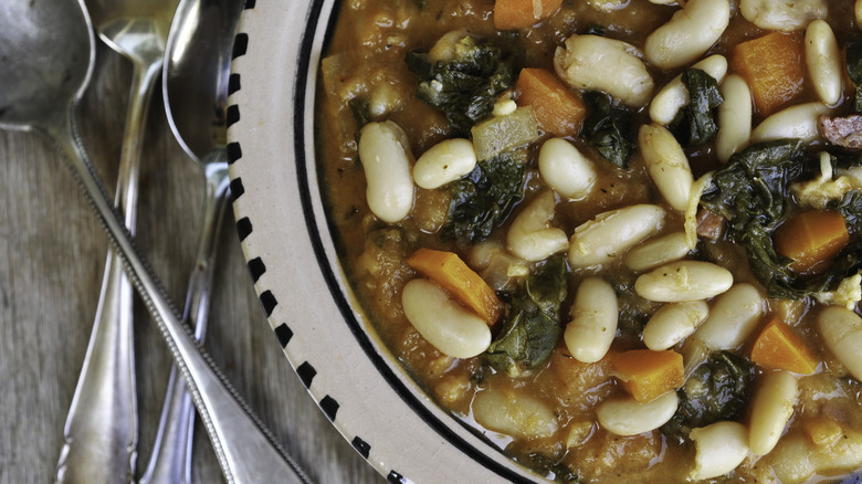 Ribollita soup in bowl with silverware next to it