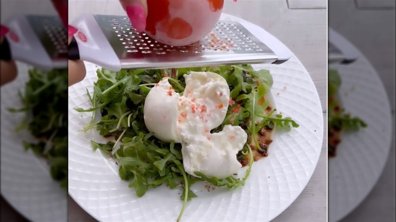 Frozen tomato grated onto burrata