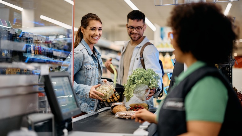 People talk to a cashier