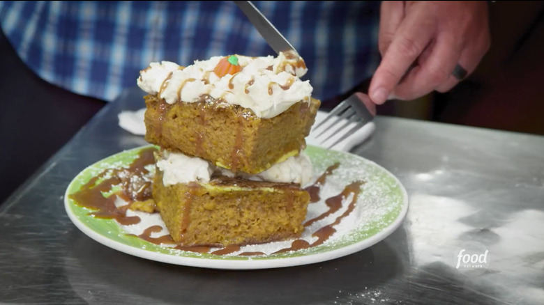 Guy Fieri cutting into pumpkin bread French toast