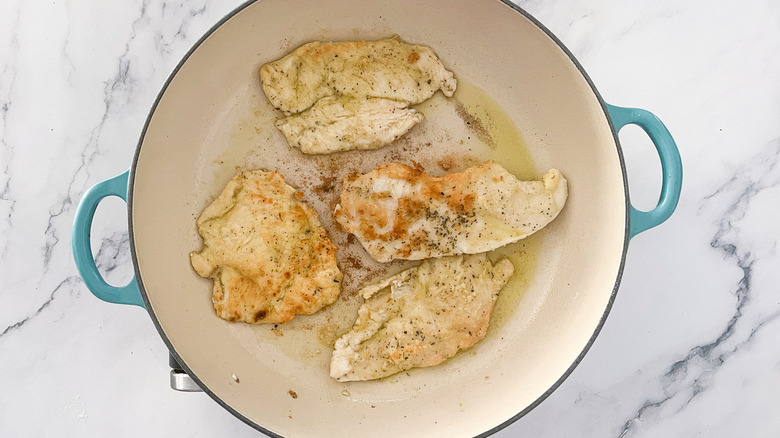 chicken cooking in skillet