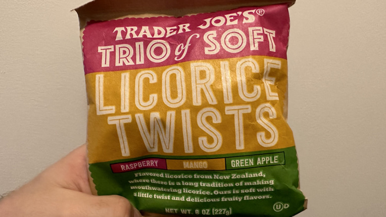 Hand holding a bag of soft licorice twists from Trader Joe's.