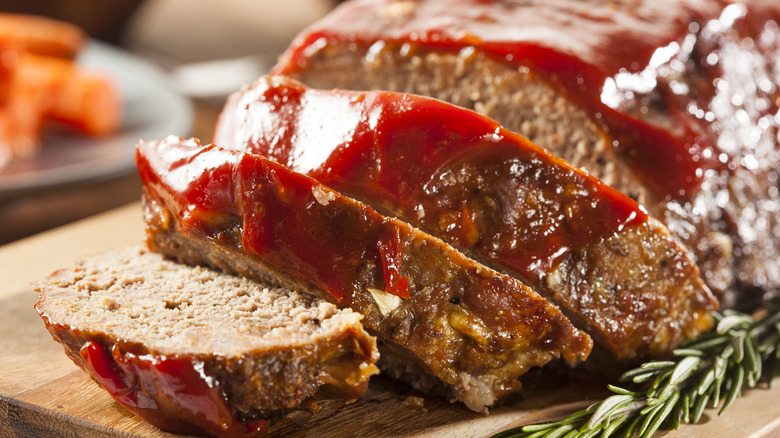 Sliced meatloaf on wooden board