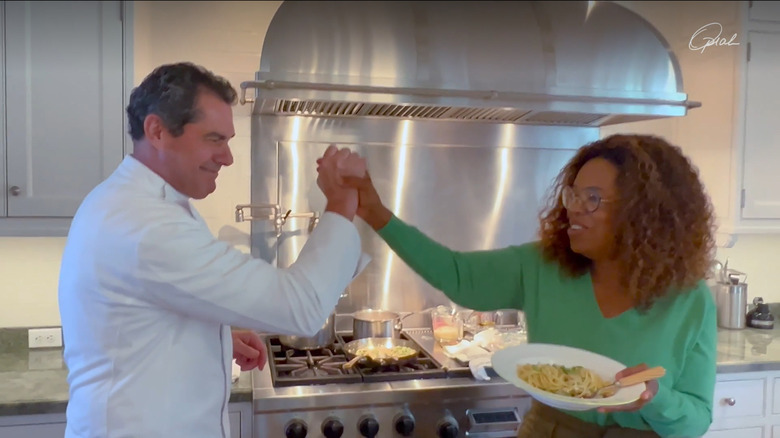 Oprah Winfrey high-fiving her chef