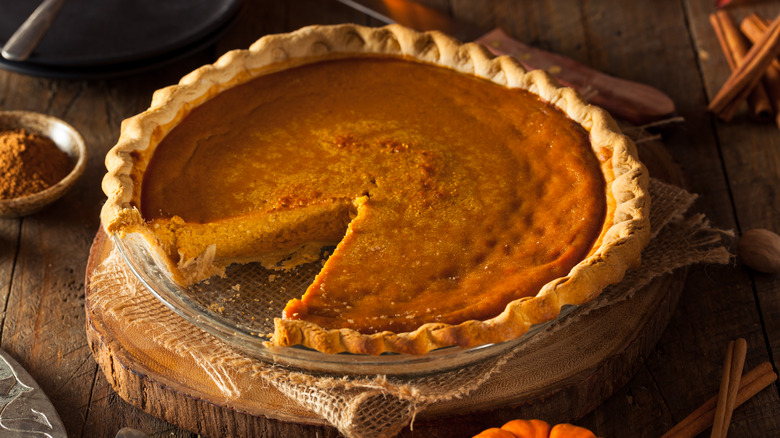 Pumpkin pie with slice cut out