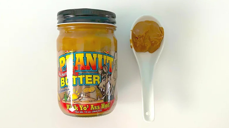 Spoonful and jar of Ass Kickin' Kick Yo' Ass Hot! Creamy Peanut Butter