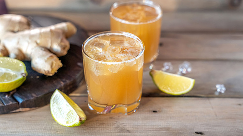 ginger ale soda in a glass with ice with whole ginger