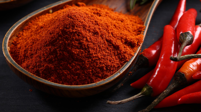 A mound of cayenne pepper in a small wooden dish