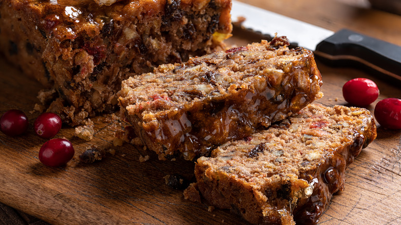 Sliced fruitcake on wooden board