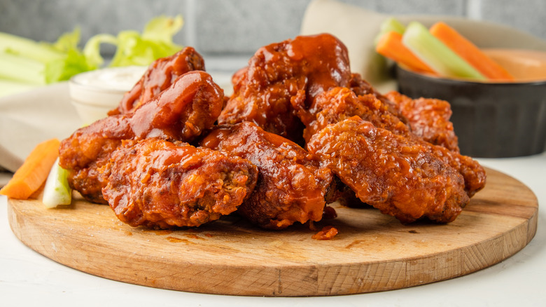 Close up of chicken wings with celery and carrots