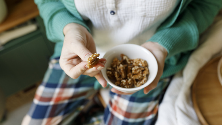 person eating walnuts