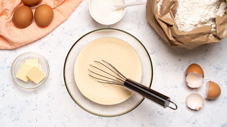 bowl of batter with whisk and ingredients