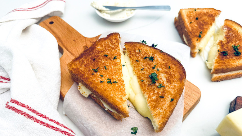 grilled cheese sandwich on wood board