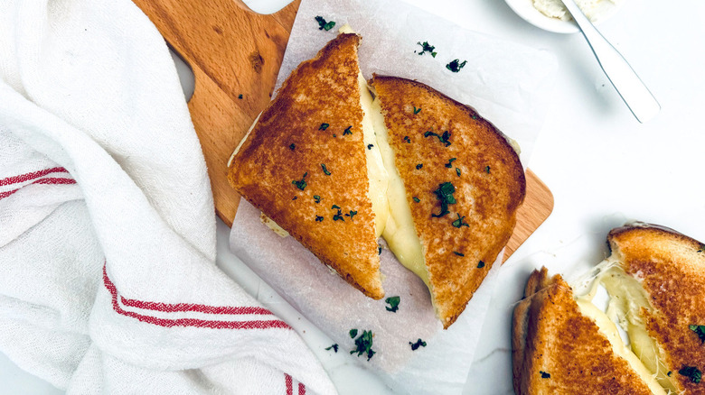 grilled cheese sandwich on wood board