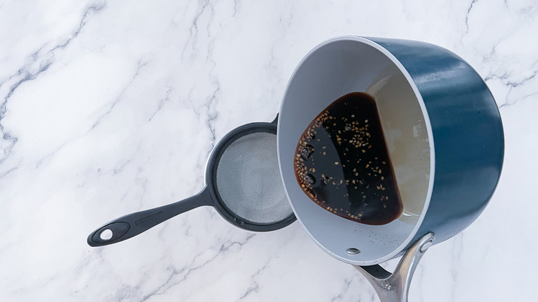 pot pouring over small sieve