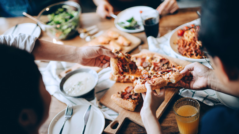 People sharing a pizza 