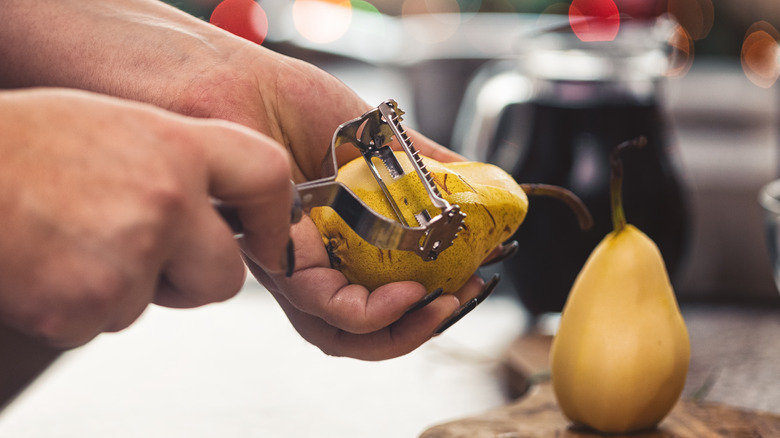 Person peeling pears