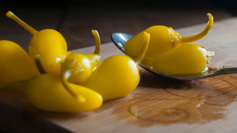 Pepperoncini on a cutting board