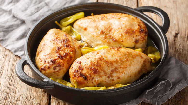 Chicken and pepperoncini in a dish.