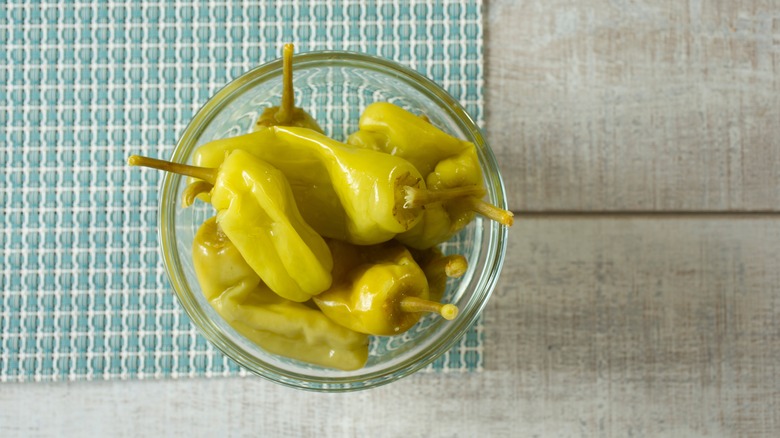 Pickled pepperoncini in a bowl.