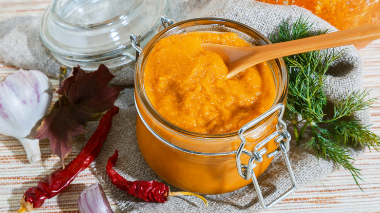 Jarred pumpkin puree next to salad dressing ingredients