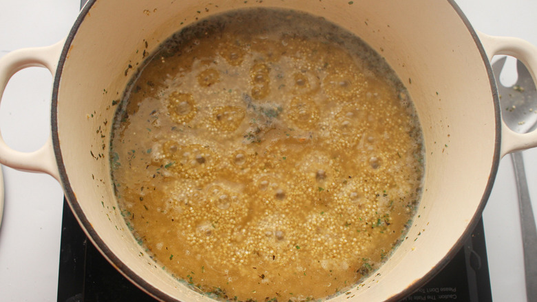 quinoa and seasonings in broth