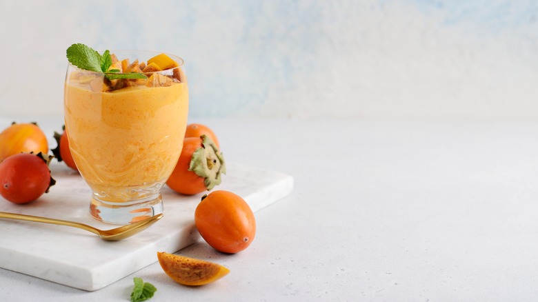 persimmon smoothie in glass with mint