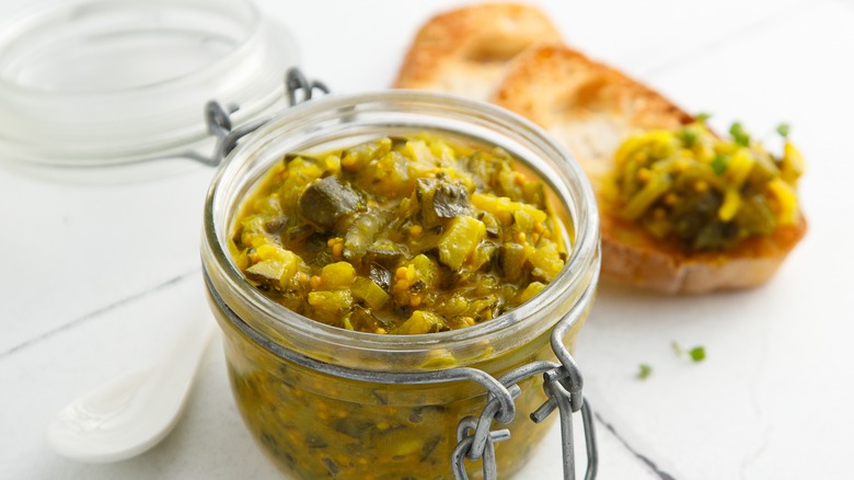 jar of pickle relish and relish on toasted baguette