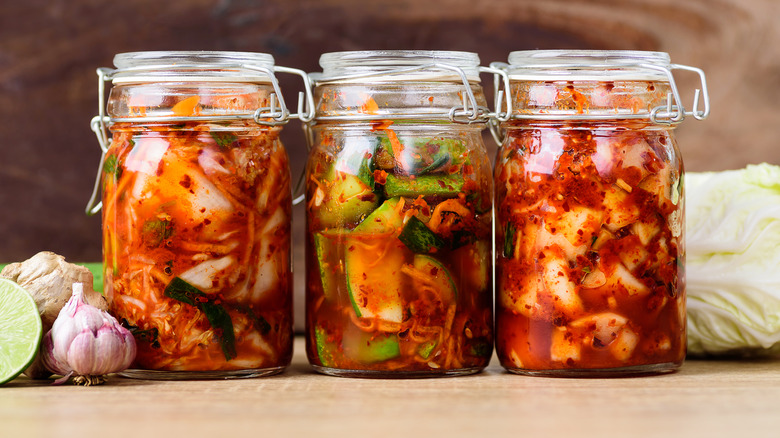 Three different jar of kimchi next to each other