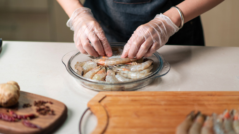 Preson preparing shrimp 