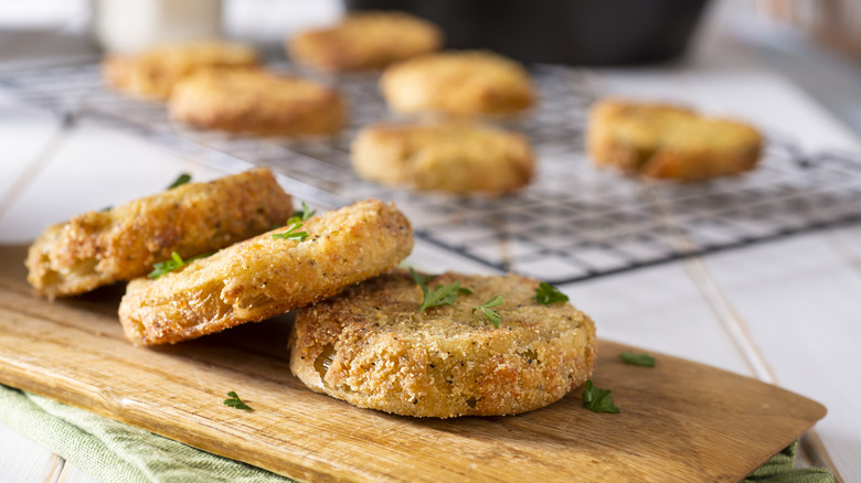 Fried green tomatoes on a wooden board