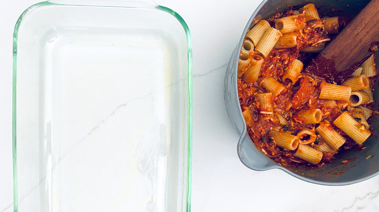 pot of pasta next to empty dish