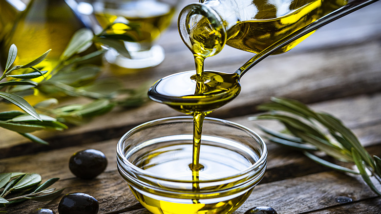 pouring olive oil into bowl