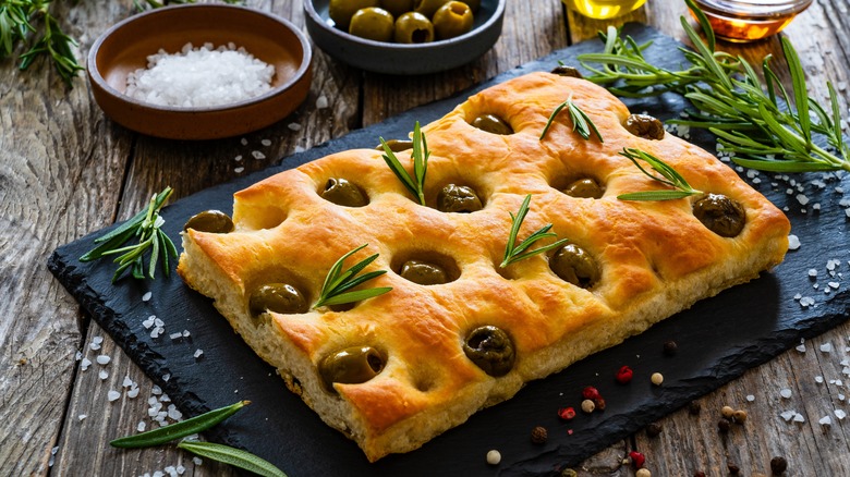 olive focaccia on black board