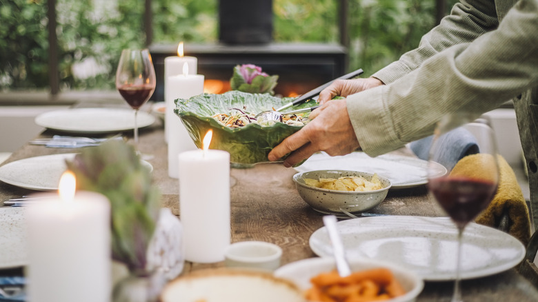 hands setting dish on a table