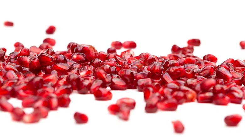 Pomegranate seeds on white background 