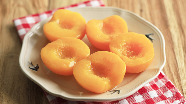 canned peach halves in bowl