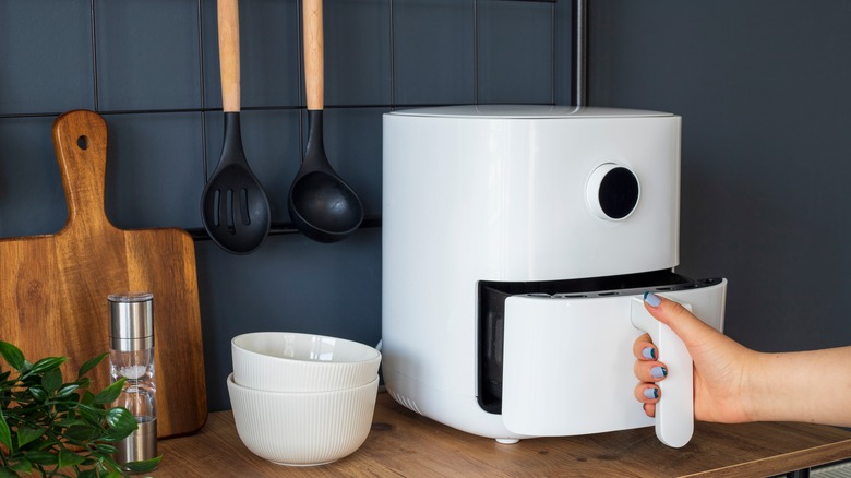 Person using white air fryer