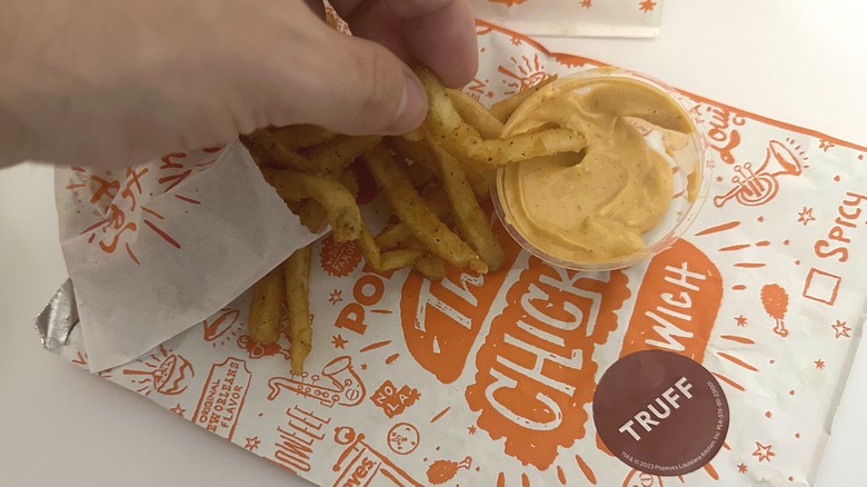 dipping fries in spicy mayo