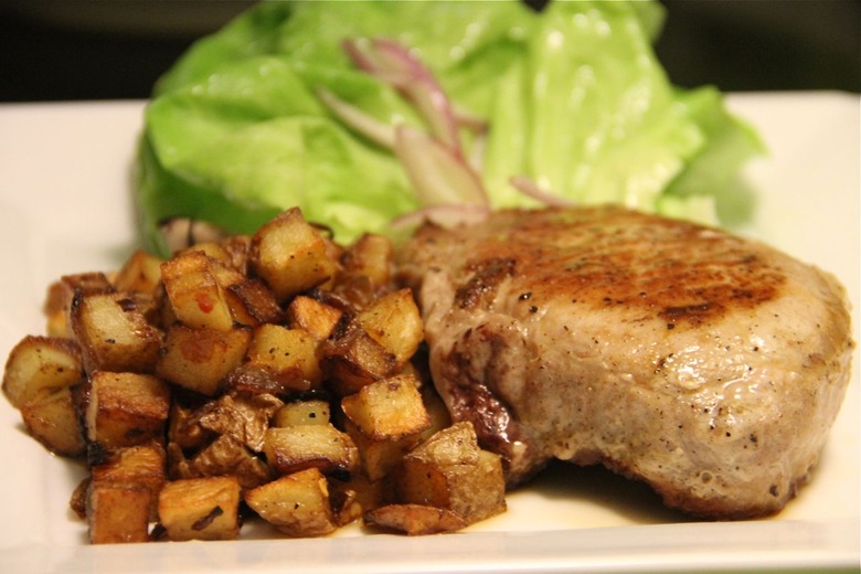 Pork chop with red pepper flake flecked potatoes.