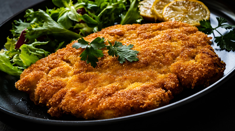 Breaded pork on plate with salad