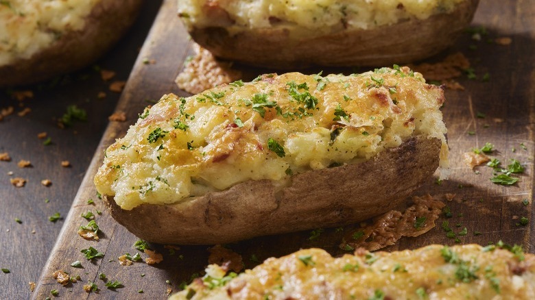 twice-baked potatoes on a rustic cutting board