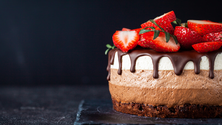 Chocolate mouse cake with a chocolate icing and strawberries