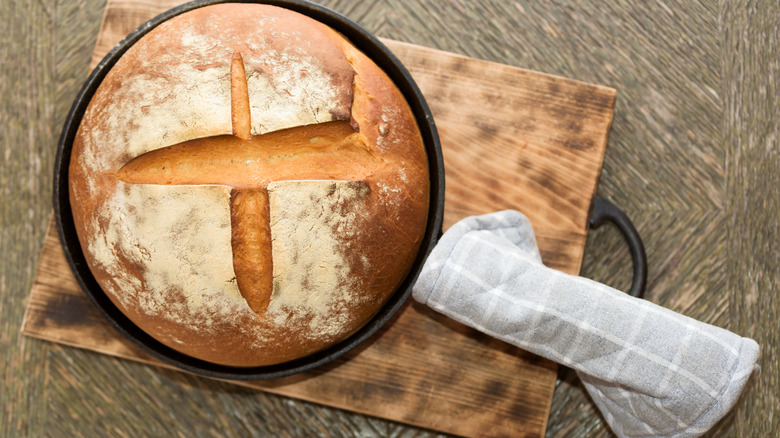 Bread in cast iron skillet with potholder