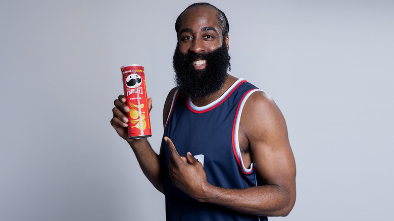 James Harden holding a can of Pringles with a gray background