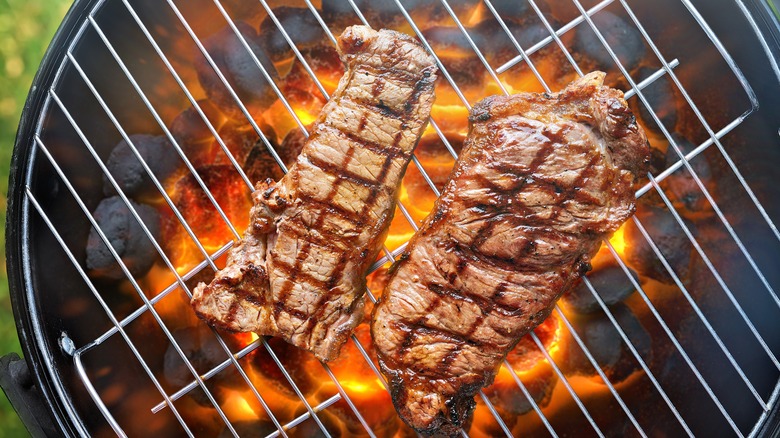 Seared steak on charcoal grill 