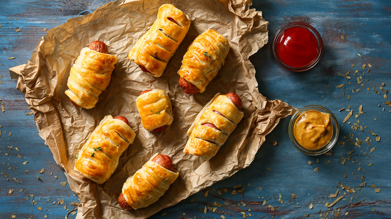 Puff pastry pigs in blankets on parchment